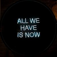 white-all-we-have-is-now-neon-signage-on-black-surface-1580625